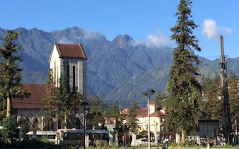 Stone Church in Sapa with mountain backdrop on cultural tour.