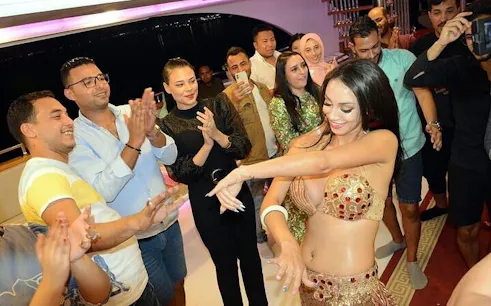 Belly dancer performing for guests on Sharm El Sheikh dinner cruise.