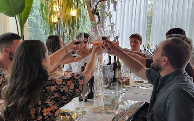 Group toasting wine at a Tuscany winery tasting event.