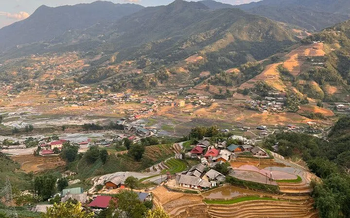 Sapa terraced rice fields and village landscape with mountains in Vietnam.