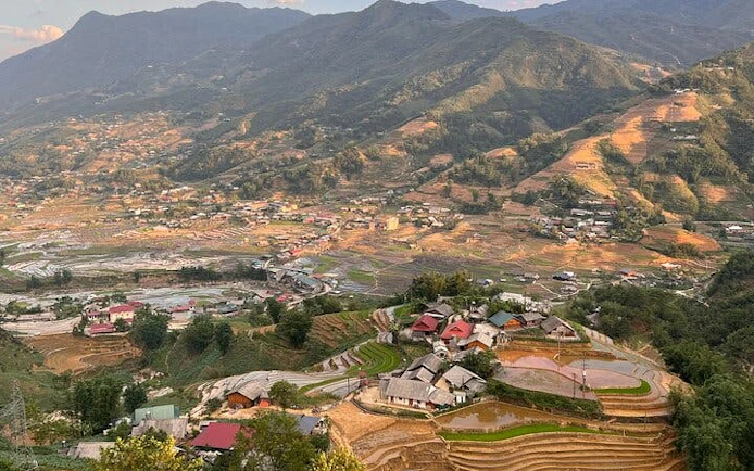 Sapa terraced rice fields and village landscape with mountains in Vietnam.