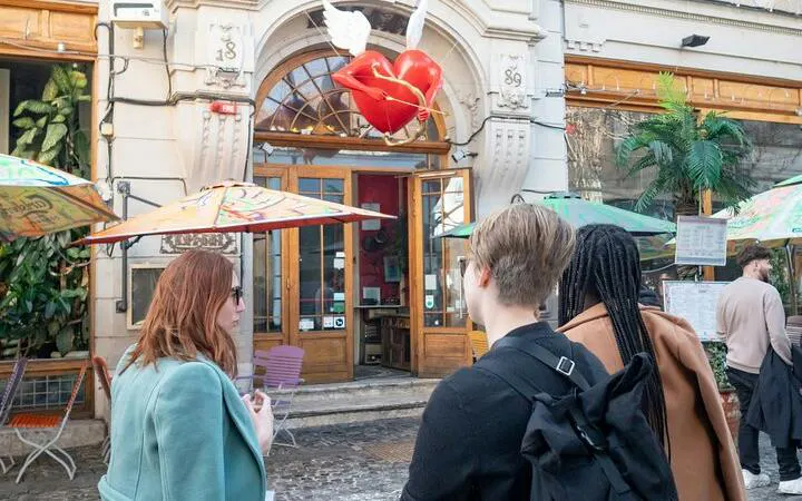 Visitors exploring a café in Bucharest Old Town during a city highlights walking tour.