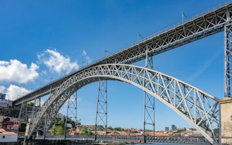 Dom Luís I Bridge spanning the Douro River in Porto, Portugal, seen on a self-guided audio walking tour.
