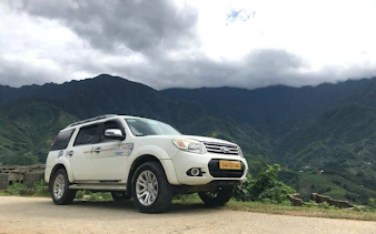 Private car on scenic mountain road from Sapa to Ha Noi, Vietnam.
