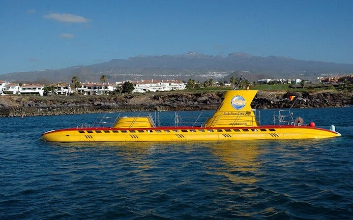 Yellow submarine on water with Tenerife mountains in the background.