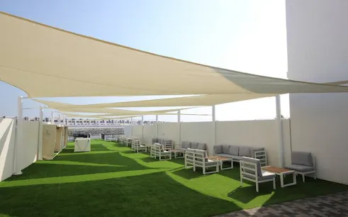 Outdoor seating area with shade sails at Fujairah dive site facilities.