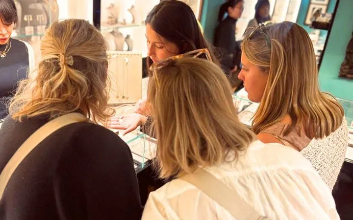Group exploring artisan jewelry shop in Oltrarno, Florence.