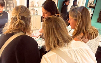 Group exploring artisan jewelry shop in Oltrarno, Florence.