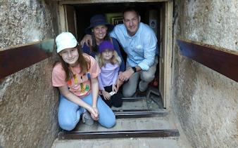 Family exploring a narrow passage inside the Giza Pyramid during a guided tour in Egypt.