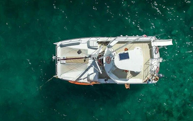 Catamaran sailing in clear waters during Punta Cana snorkeling tour.