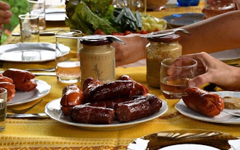 Cheese and sausage tasting at a bonfire feast in Zakopane during a guided adventure tour.