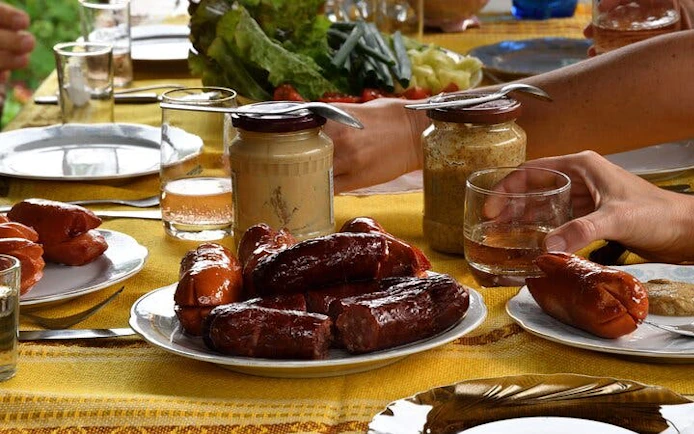 Cheese and sausage tasting at a bonfire feast in Zakopane during a guided adventure tour.