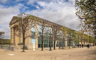 Musée de l'Orangerie exterior with visitors walking nearby in Paris.