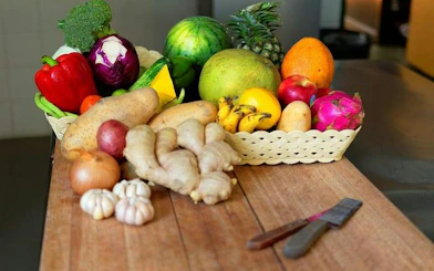 Fresh ingredients for Chiang Mai Thai cooking class at Baan Hongnual, including ginger and tropical fruits.