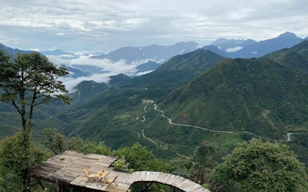 Sa Pa mountain view with winding road and wooden deck, Vietnam.