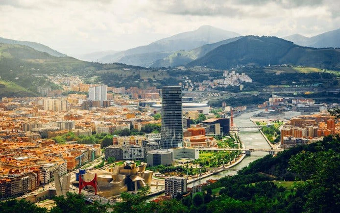 Bilbao cityscape with Guggenheim Museum and Nervión River, view from above.