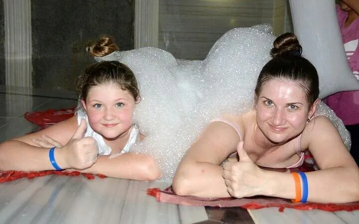 Two people enjoying a Turkish bath with foam in Sharm El Sheikh spa.