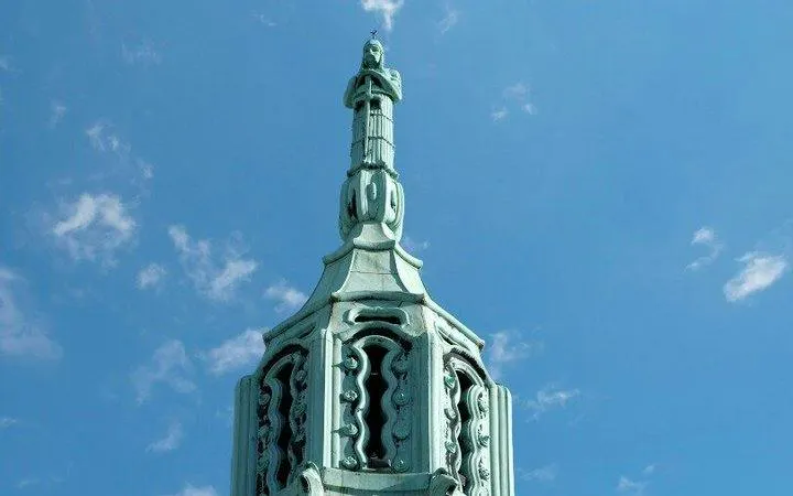 Debrecen building spire against blue sky on self-guided audio walking tour.