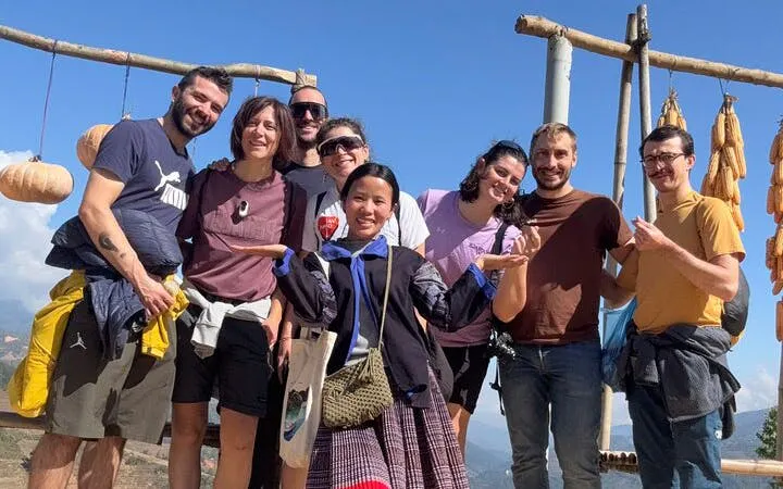 Group of tourists with a local guide on a private car tour from Sapa to Mu Cang Chai Rice Terraces.