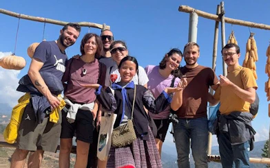 Group of tourists with a local guide on a private car tour from Sapa to Mu Cang Chai Rice Terraces.