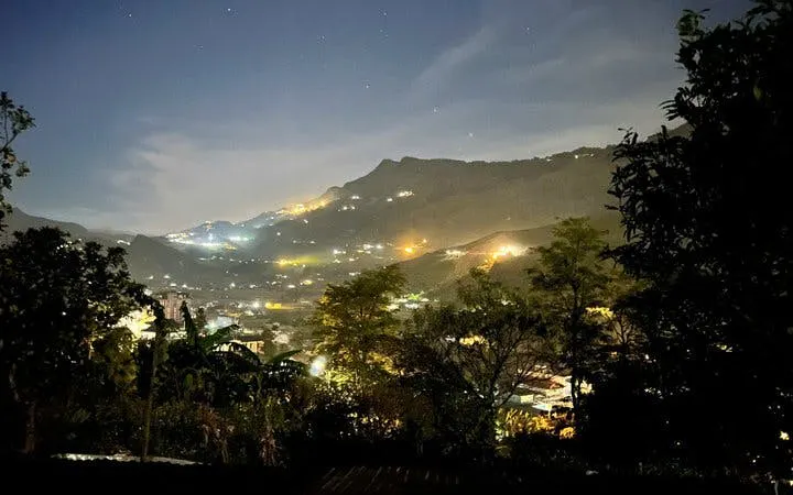 Sapa valley at sunset with illuminated hills and village lights, Vietnam.