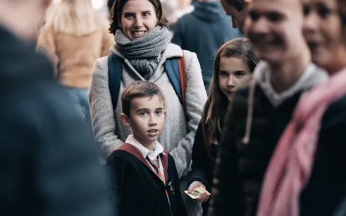 Group of people on a Harry Potter filming locations tour with interactive games.