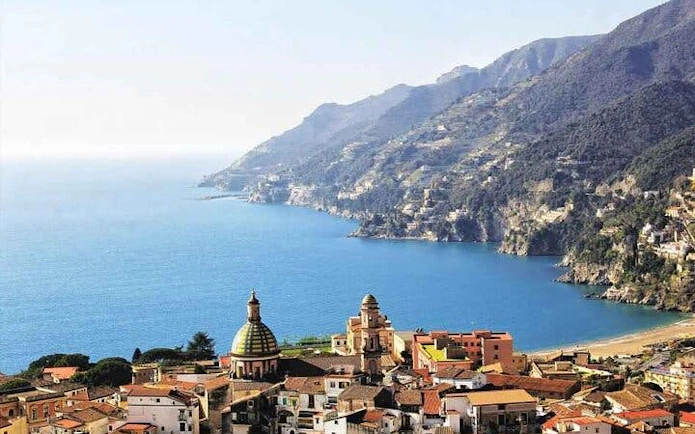 Amalfi Coast view with colorful buildings and coastline, Italy.