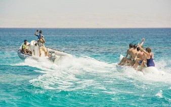 Group enjoying banana boat ride on clear waters in Sharm El Sheikh.