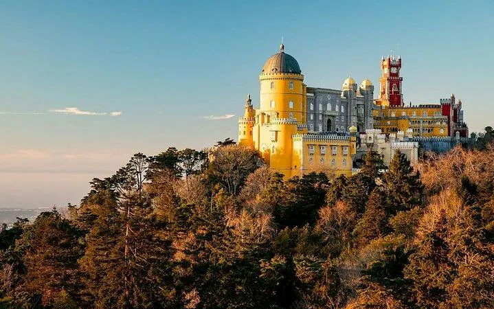 Pena Palace in Sintra surrounded by lush forest, part of a private tour with Moorish Castle tickets.