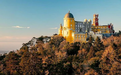 Pena Palace in Sintra surrounded by lush forest, part of a private tour with Moorish Castle tickets.