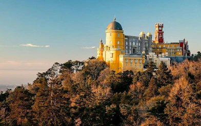 Pena Palace in Sintra surrounded by lush forest, part of a private tour with Moorish Castle tickets.