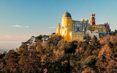 Pena Palace in Sintra surrounded by lush forest, part of a private tour with Moorish Castle tickets.