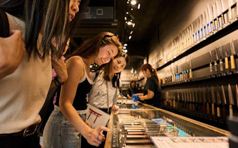 Visitors exploring a knife shop in Asakusa during a Tokyo walking tour.