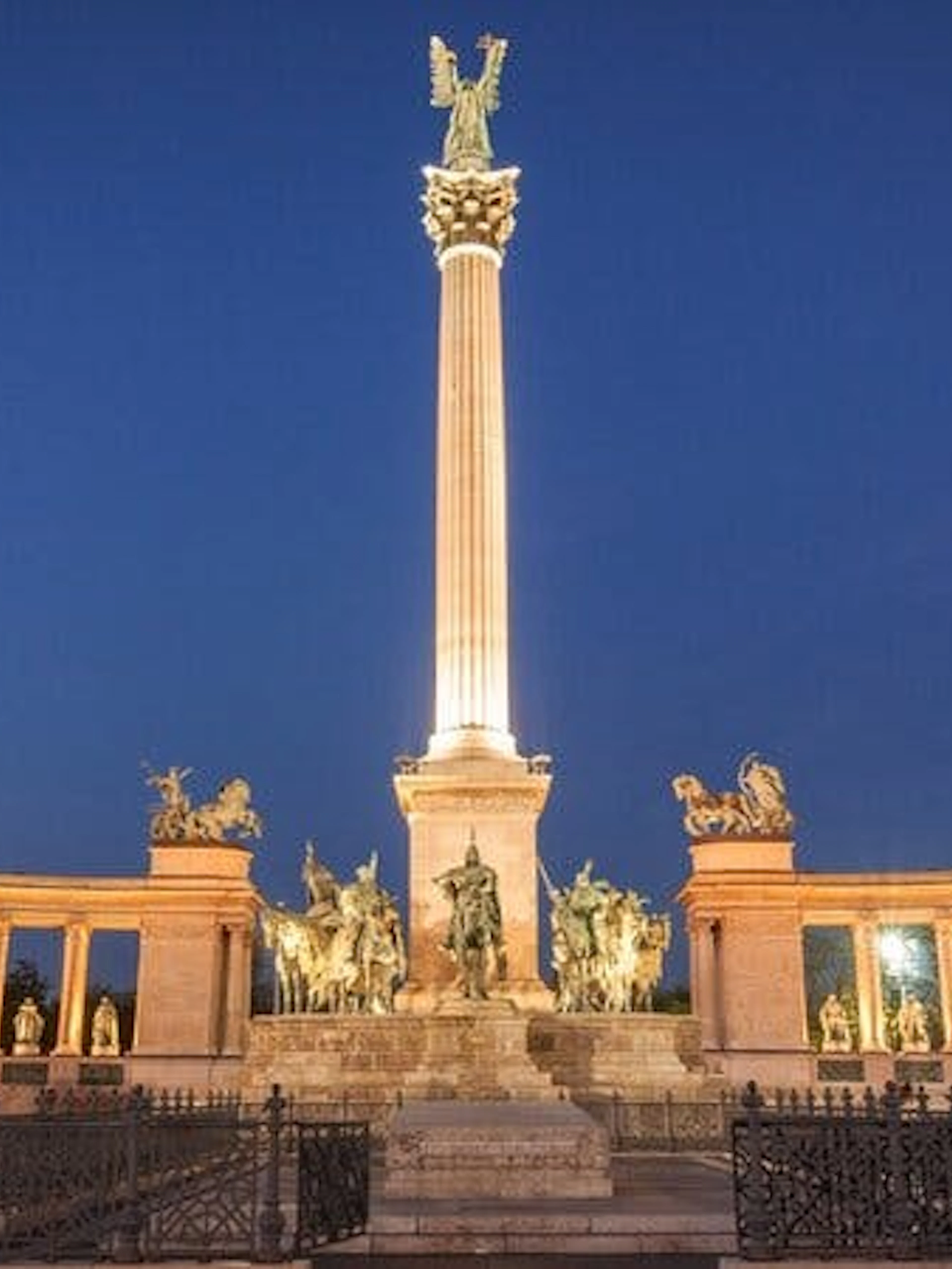 Heroes' Square in Budapest illuminated at night, part of the Ghosts of Budapest exploration game.