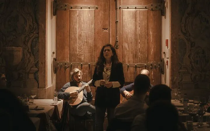 Portuguese singer performing Fado at Mesa de Frades Chapel in Lisbon with musicians.
