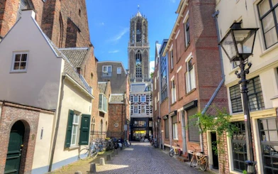 Utrecht street with Dom Tower in background, part of self-guided city exploration game.