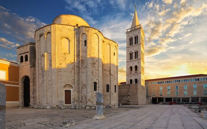 Zadar's Church of St. Donatus and bell tower at sunset, featured in self-guided walking tour app.