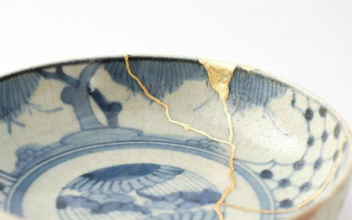 Kintsugi-repaired ceramic bowl with gold seams in Namba, Osaka workshop.