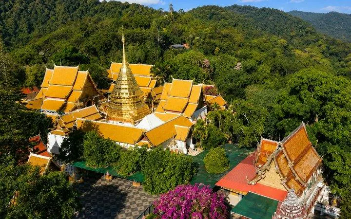Wat Phra That Doi Suthep temple complex surrounded by lush greenery in Chiang Mai.