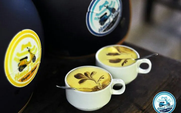 Two cups of Vietnamese egg coffee on a table during Hanoi Vespa street food tour.