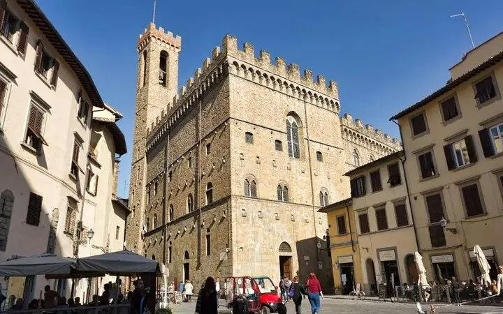 Bargello Museum exterior in Florence with visitors in the courtyard.