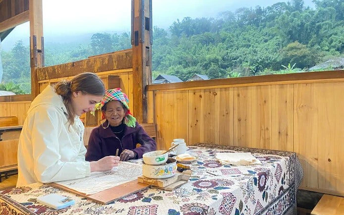 Batik painting workshop with Hmong artisans in Ta Van, Vietnam, featuring traditional techniques.