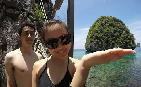 Tourists enjoying the view of a limestone island in Phi Phi Islands, Phuket.