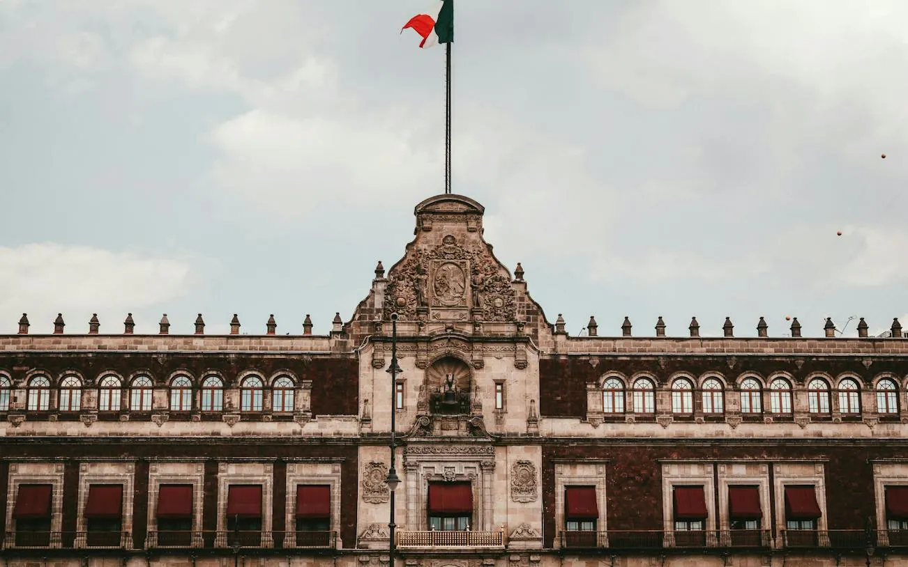 Historic building facade with Mexican flag in Mexico City's Centro Histórico.