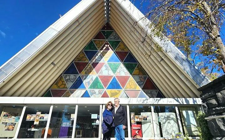 Cardboard Cathedral entrance with colorful triangular stained glass, Christchurch City Top Spots Half Day Tour.