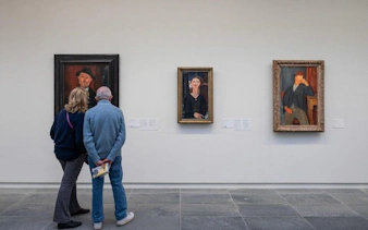 Visitors viewing paintings at Musée de l'Orangerie, Paris.