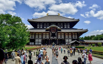 Todai-ji Temple in Nara with visitors walking towards the entrance.