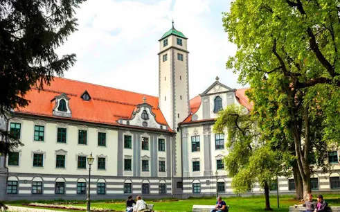 Augsburg historical building with red roof and tower, part of self-guided walking tour.