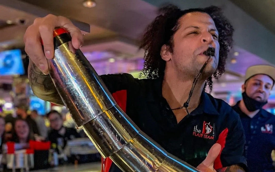 Bartender performing flair with shaker during Downtown Las Vegas bar crawl.