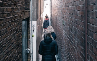 Walking tour group in narrow alley during Little Venice ghost walk.